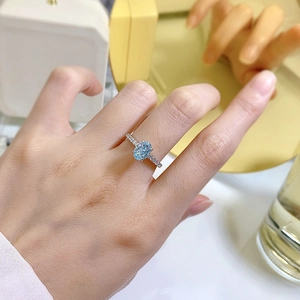 925 silver ring with oval light blue zircon and micro-paved diamonds on finger