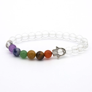 Detailed close-up of handmade chakra beaded bracelet with silver Hamsa hand charm