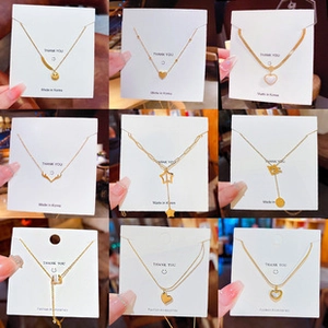 Collage of diverse 18K gold plated titanium steel necklaces with unique charms in a grid
