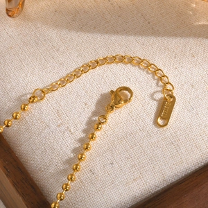 Macro shot of gold stainless steel ball chain with spring clasp and extension chain