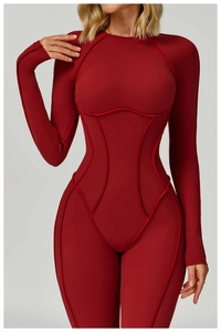 Detailed view of burgundy yoga bodysuit with ergonomic contour stitching and slim fit