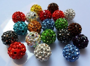 Macro shot of colorful clay pave disco beads with sparkling rhinestones for jewelry making