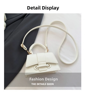 Detail of white lychee pattern PU leather mini handbag with double ring buckle and strap
