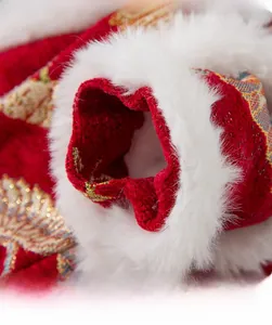 Detailed macro view of red jacquard fabric with gold embroidery and white plush cuffs