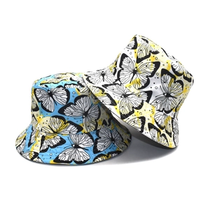 Double-sided reversible bucket hats with butterfly prints in blue and yellow-white