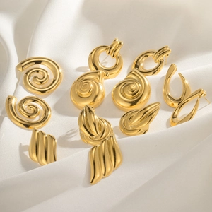 Chic gold shell earrings and geometric alloy studs set on elegant white satin background