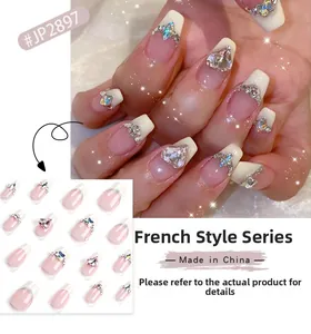 Close-up of French Series press-on nails with heart rhinestones and silver accents