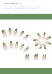 Detail of aurora gradient press-on nails with green heart gems and rhinestones