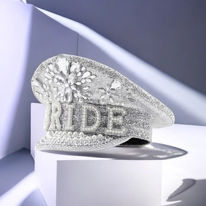 Detailed view of silver sequins and large pearls with BRIDE lettering on a captain hat