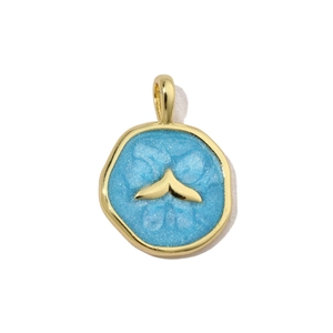 Detail of round gold pendant with blue enamel, glitter finish and whale tail motif