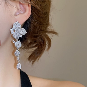 Macro view of luxurious zircon drop earrings with shimmering fringe and petal design