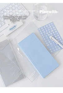 Detail view of a soft blue PU planner notebook with a transparent cover and alphabet stickers
