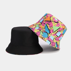 Reversible bucket hat featuring solid black design and retro colorful geometric print