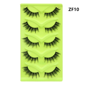 Detailed view of 5 pairs of thick cat-eye false eyelashes on a green tray