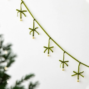Dark green velvet Christmas banner with handmade bows and golden bells for party decor