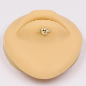 Golden heart arrow body piercing jewelry with clear zircon stones on skin model