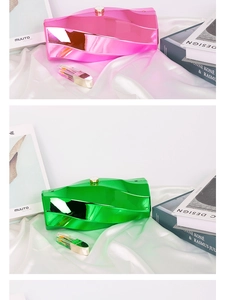 Detailed close-up of metallic irregular box clutch bags with glossy wave design and sphere clasp