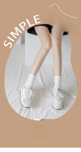 Detail of white cotton slouch socks with elastic ribbed cuffs for women worn with sneakers