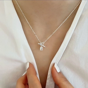Macro view of sterling silver necklace featuring rectangle zircon and a T-bar pendant