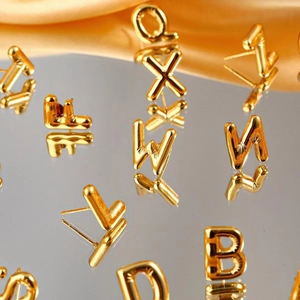 Polished gold plated titanium steel alphabet stud earrings in minimalist letter designs
