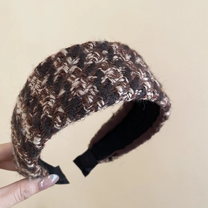 Macro shot of French tweed headband texture in brown and black with non-slip lining