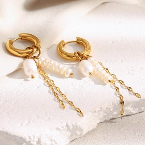 Detail of 18K gold-plated hoop earrings featuring pearl tassels and fine metal chains