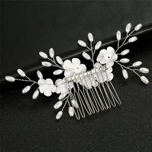 Detail of silver alloy wire hair comb with white resin flowers and faux pearls