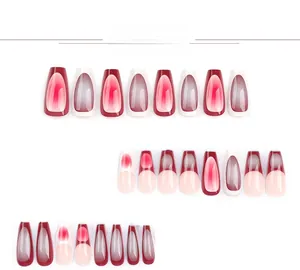 Detailed view of burgundy and purple gradient press-on nails with cat-eye and marble finish