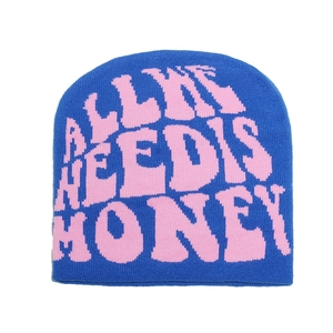 Close-up of blue knit beanie with pink ALL WE NEED IS HONEY text and detailed texture