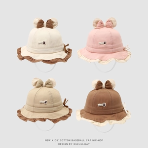 Close-up of baby sun hats with ruffle brim, bow tie, and rabbit embroidery details