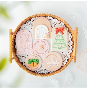 Macro view of Christmas and Valentine fondant cookie stamps on a lace paper tray