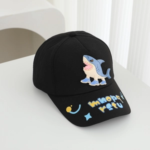 Detail of black cotton baseball cap featuring a cartoon shark and colorful brim letters