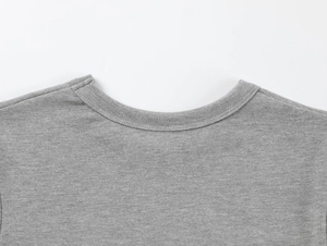 Detail view of the ribbed crewneck and shoulder seams on this grey modal athletic t-shirt