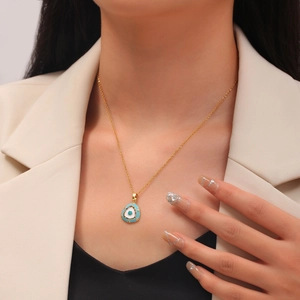 Evil Eye pendant necklace in gold with blue enamel and sparkling crystal accents