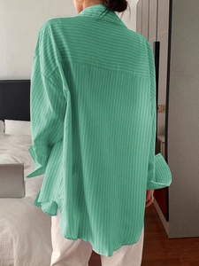 Women's casual green striped long sleeve blouse in a loose fit with white pants