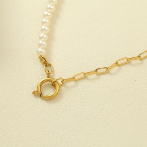 Detail of pearl and gold link necklace showing the spring clasp and fine textures