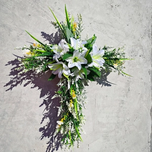 Easter floral cross wreath with white lilies and green leaves for door hanging decoration