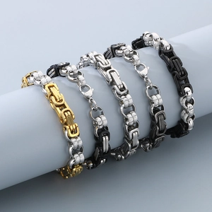 Detail of masculine Byzantine link bracelets in gold and silver steel on a blue pedestal