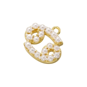 Macro shot of gold-plated metal and pearl pendant in a curly digit shape with hook