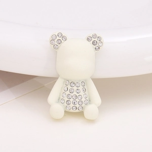 Close-up of a white cartoon bear resin charm with sparkling rhinestones for DIY accessories