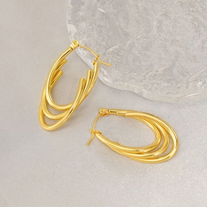 Multi-layer 18K gold-plated stainless steel oval hoop earrings on textured cloth