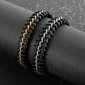 Detailed close-up of woven black leather bracelets with gold and silver metal chain links