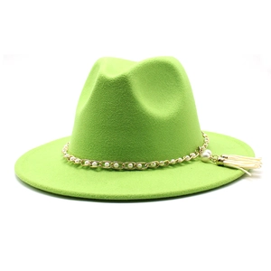 Detail of bright green wool fedora with gold chain, white pearl, and tassel accessory