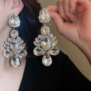 Macro view of crystal teardrop earrings with sparkling rhinestones in silver finish