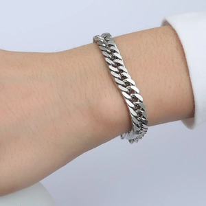 Silver Cuban link bracelet in high-quality stainless steel on a model's wrist