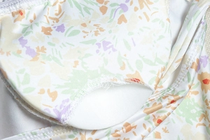 Detailed close-up of floral print fabric with high-quality stitching and soft white lining
