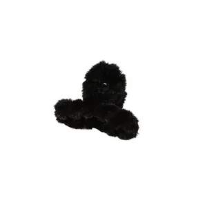 Detailed close-up of fluffy black plush hair claw clip showing soft faux fur texture