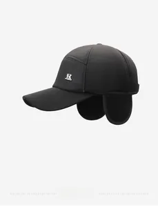 Close-up of winter baseball cap with ear flaps and metallic R logo for extra warmth
