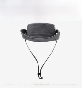 Close-up of dark grey sun hat featuring adjustable wind cord and metal air vents