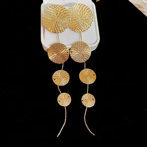 Golden long tassel earrings with textured circular discs and spiral pattern for women